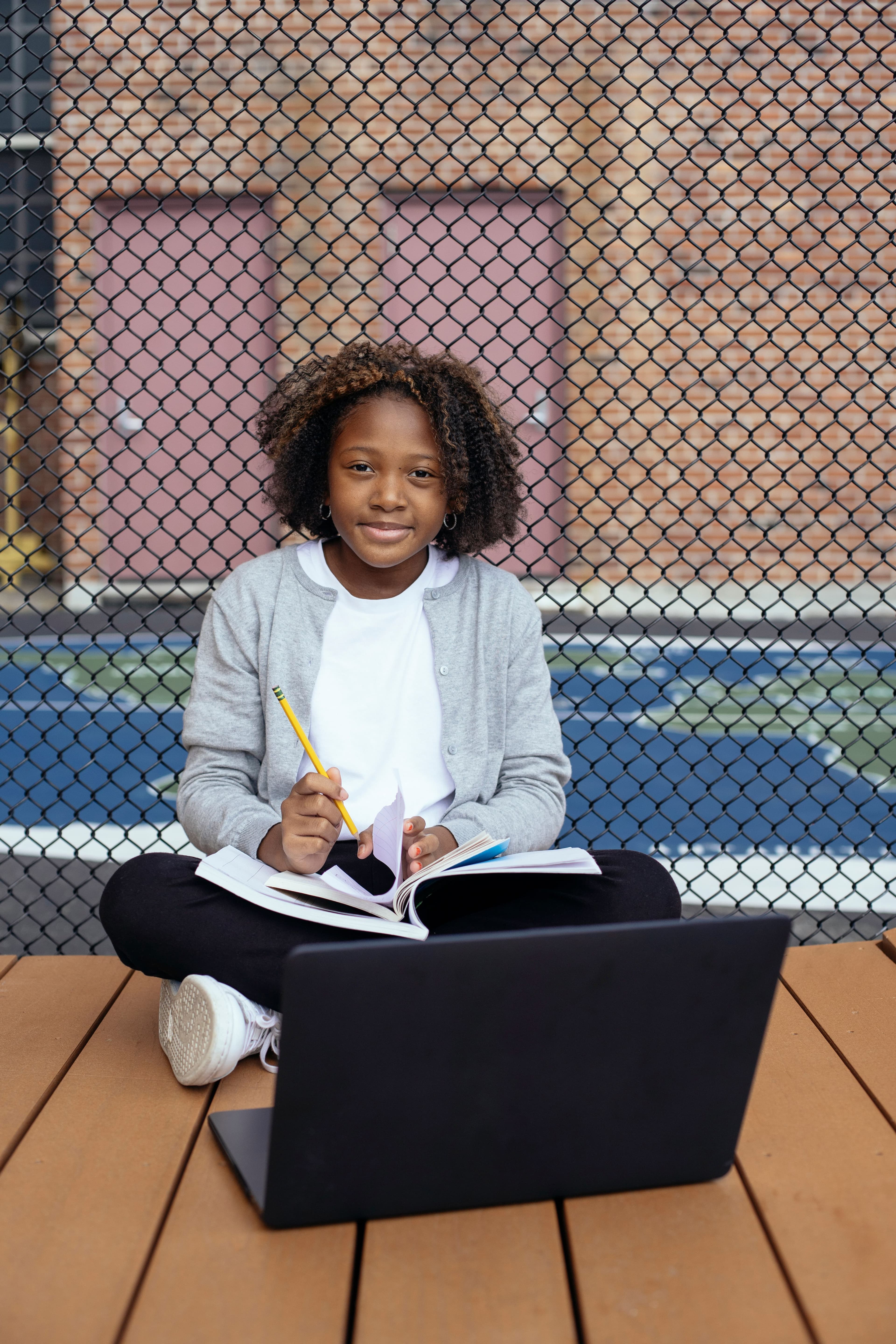 Student smiling with laptop, ready to study
