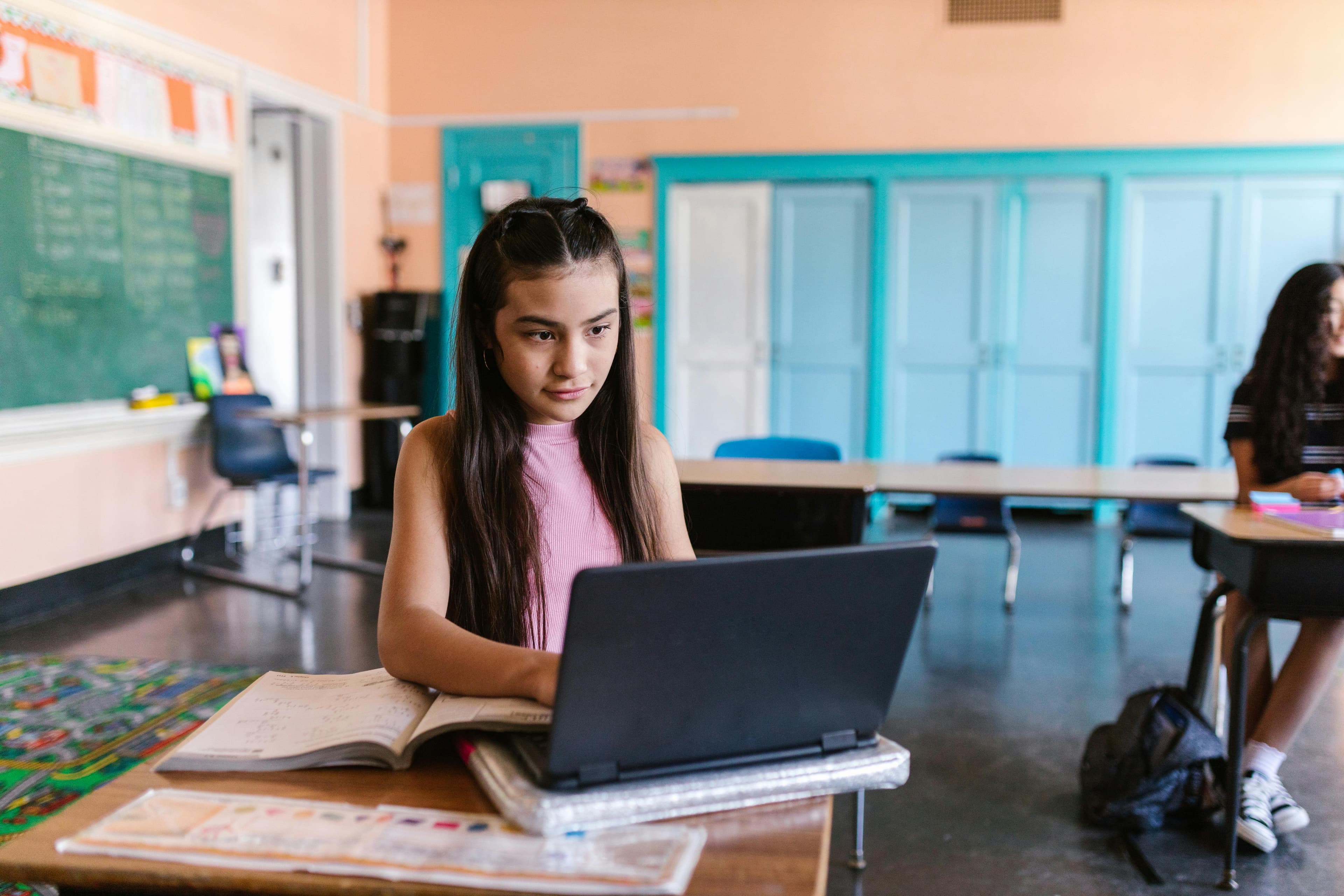 Student focused at laptop in classroom