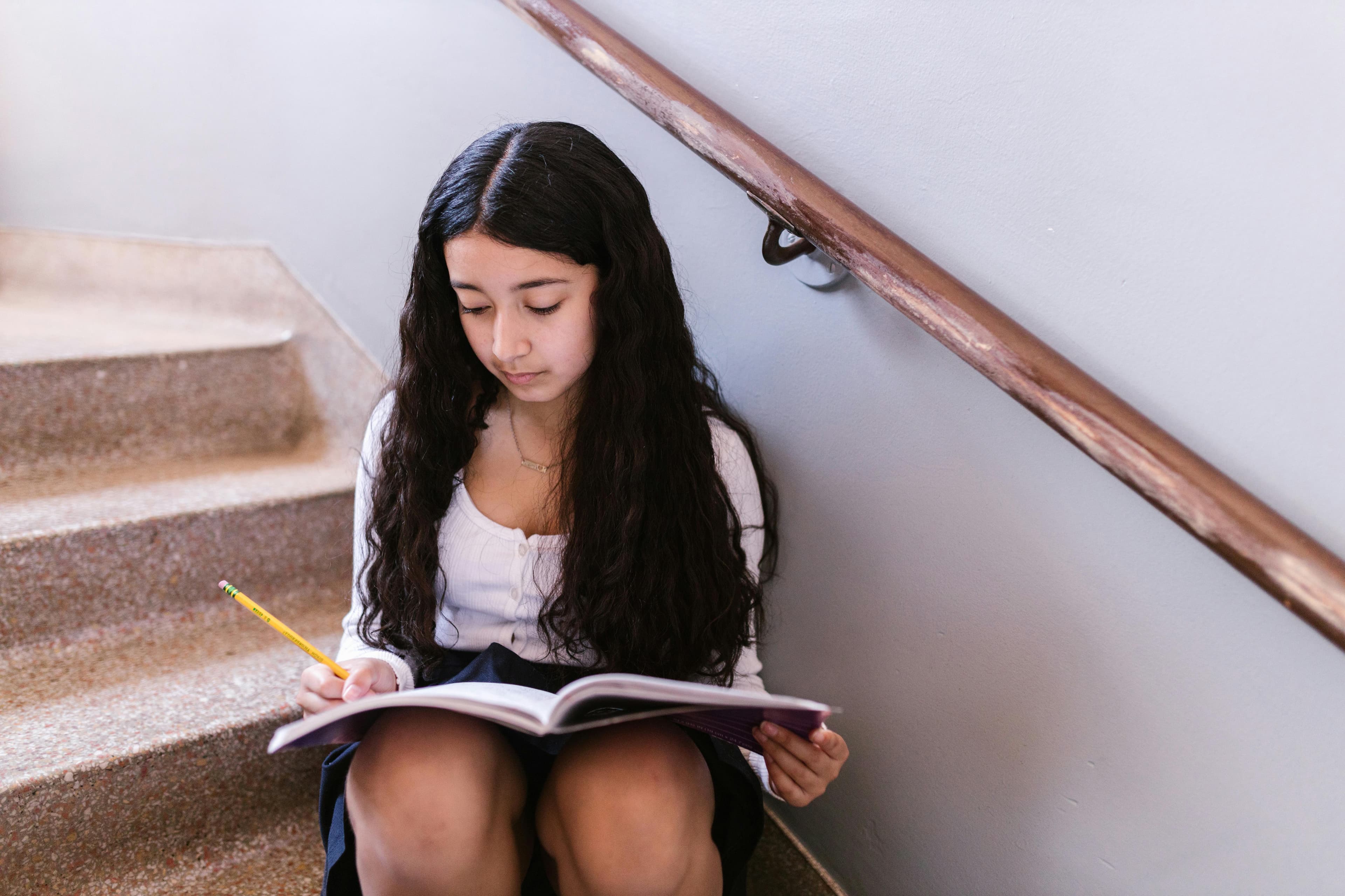 Student studying alone on stairs